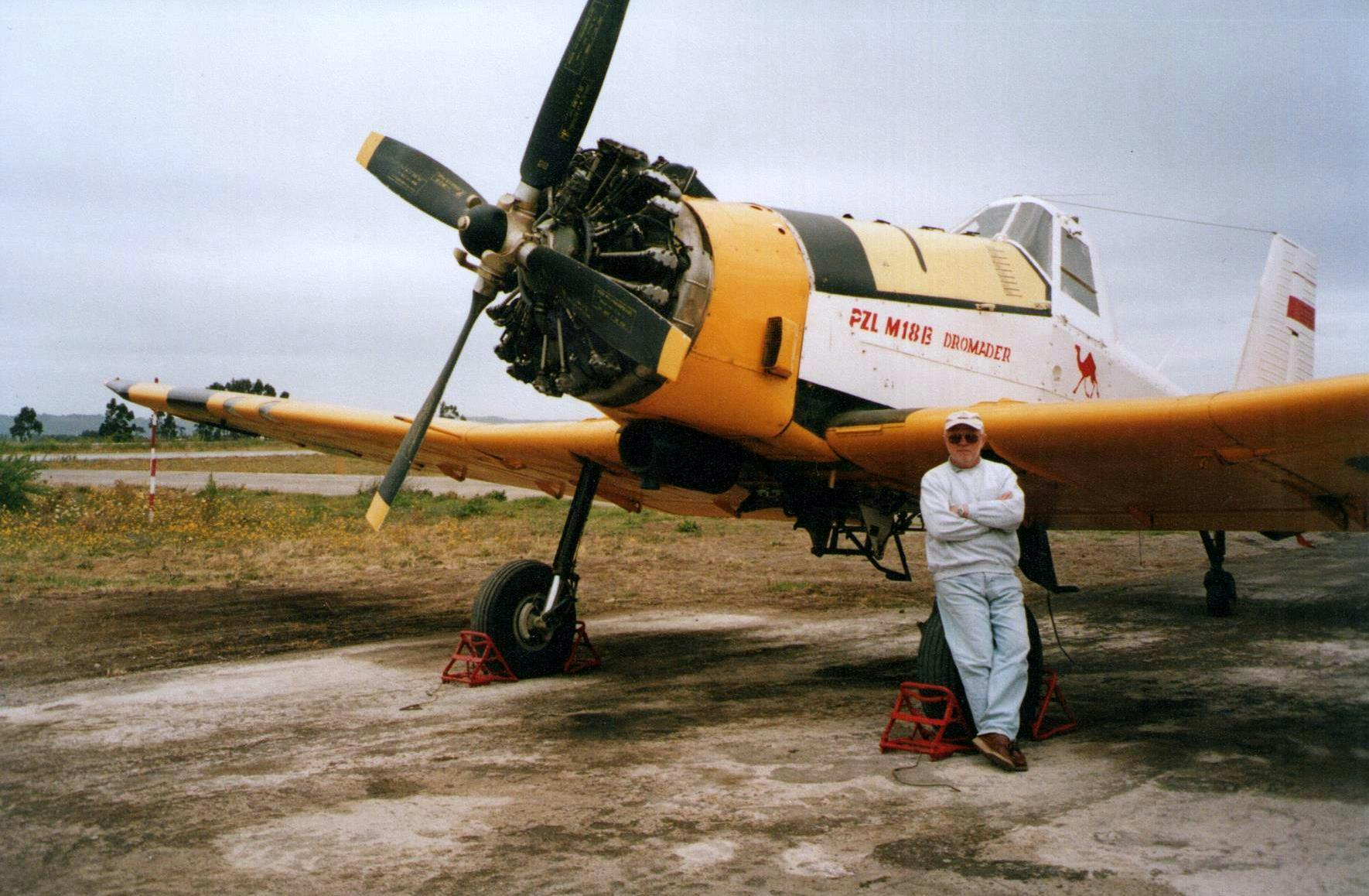 Chile, Concepcion Airport, early 21st century. Zbigniew Kowalski leans on a PZL M18 Dromader plane.