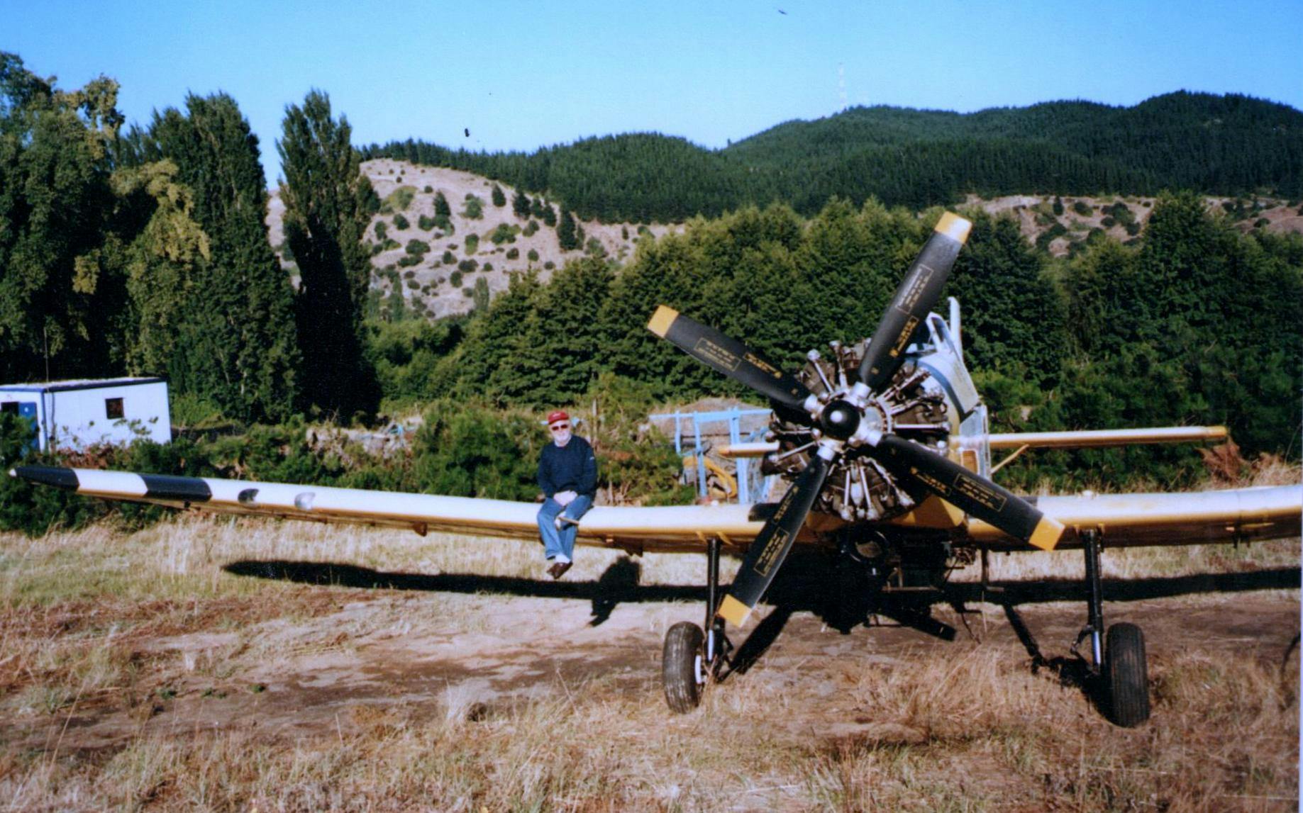 Chile, Lacha Airport, early 21st century. Zbigniew Kowalski sits on the wing of a PZL M18 Dromader plane.