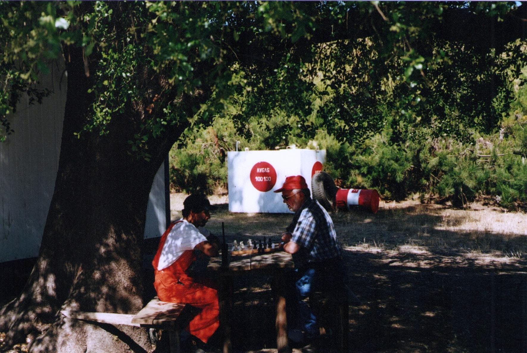 Chile, Lacha Airport, early 21st century. Zbigniew Kowalski plays chess with a Chilean operating a firewater pump at the firefighting reservoir.